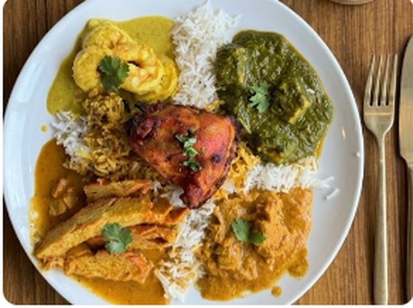Buffet plate with tandoori chicken, curries and rice
